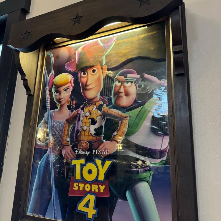 An illuminated display featuring a poster for Disney Pixar's Toy Story 4 with characters Woody, Bo Peep, and Buzz Lightyear.