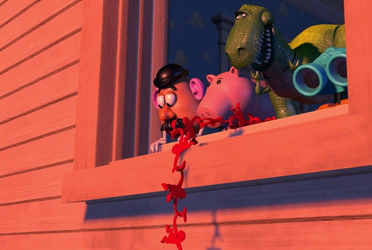 Mr. Potato Head, Hamm, and Rex looking out a wooden window frame at a chain of red plastic Barrel of Monkeys toys hanging down the outside wall.
